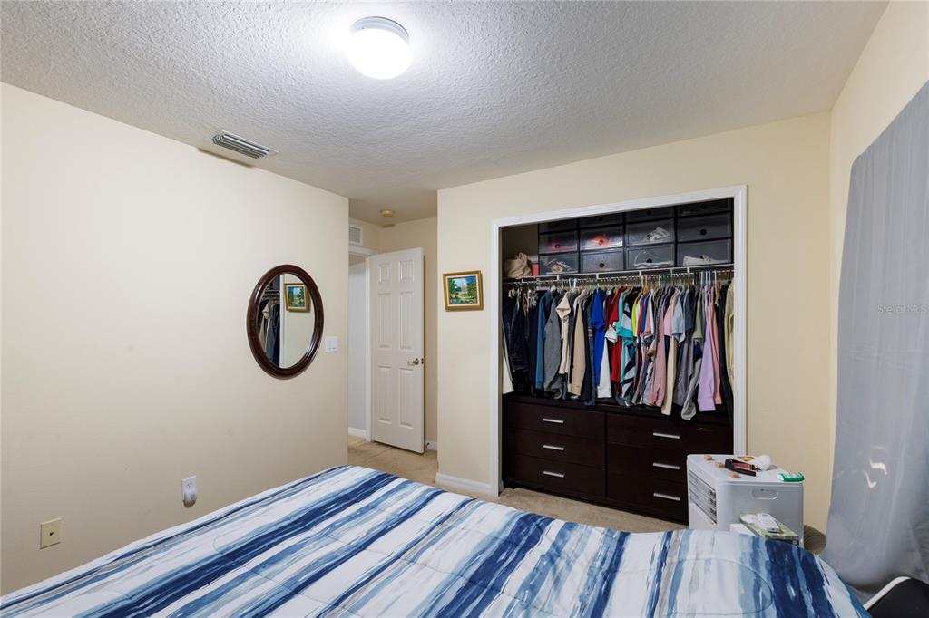 10901 Brickside Court Riverview, FL 33579 - Photo 23 of 36 a view of a hallway with wooden floor and furniture