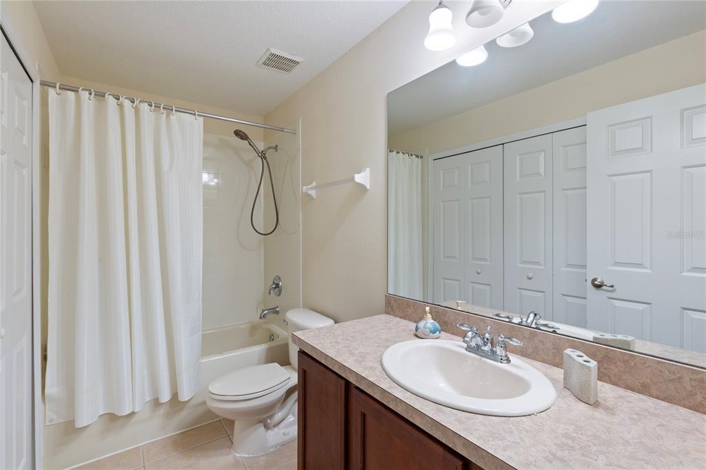 10901 Brickside Court Riverview, FL 33579 - Photo 24 of 36 a bathroom with a granite countertop sink toilet and shower
