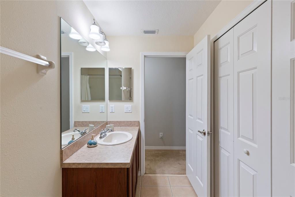 10901 Brickside Court Riverview, FL 33579 - Photo 25 of 36 a bathroom with a sink double vanity and a mirror