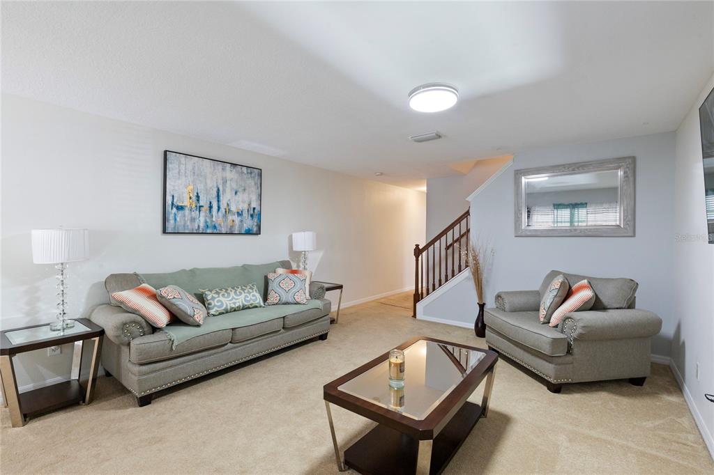 10901 Brickside Court Riverview, FL 33579 - Photo 7 of 36 a living room with furniture and a wooden floor