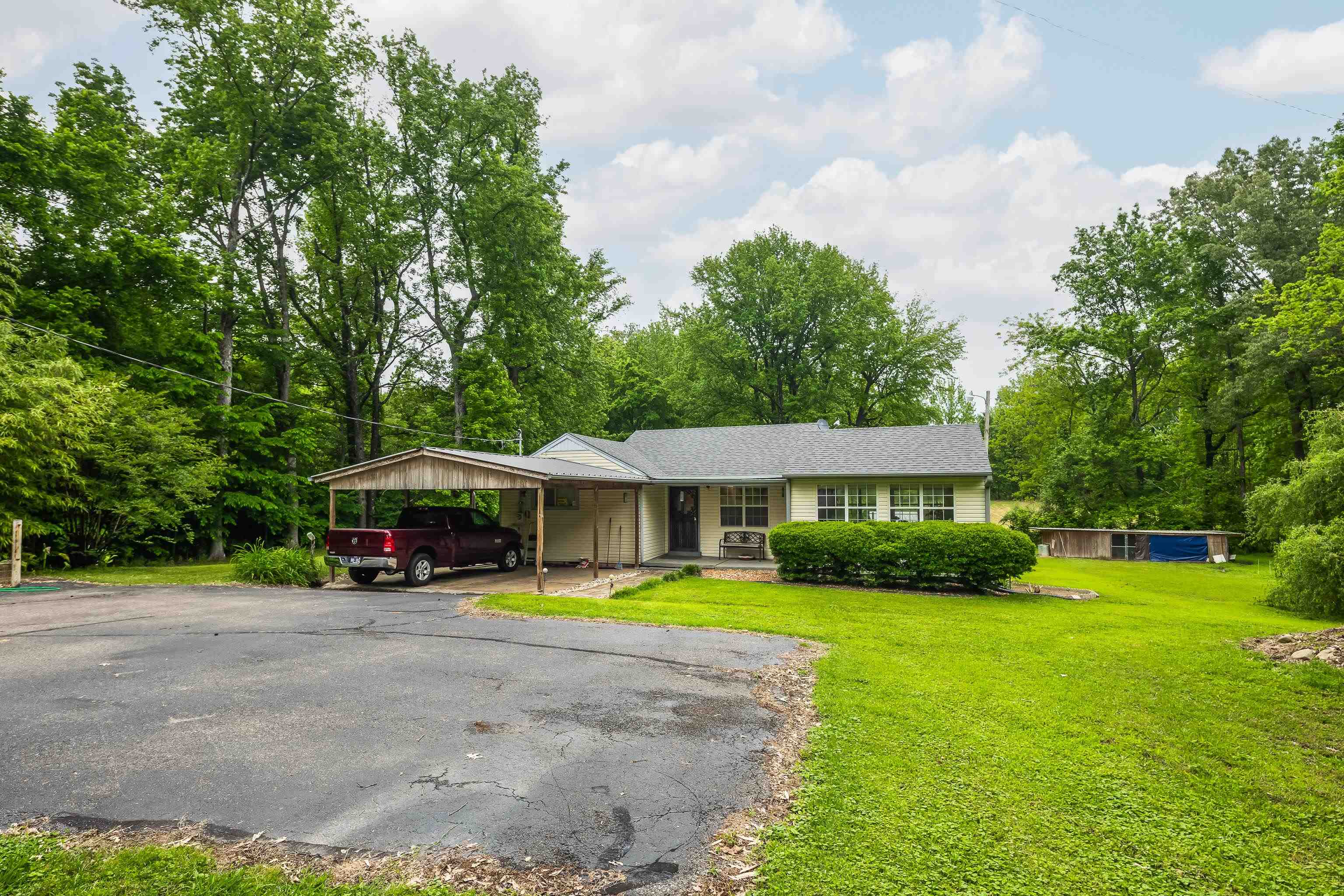 9252 Brunswick Road Millington, TN 38053 - Photo 11 of 40 a view of a patio with couches and table and chairs under an umbrella