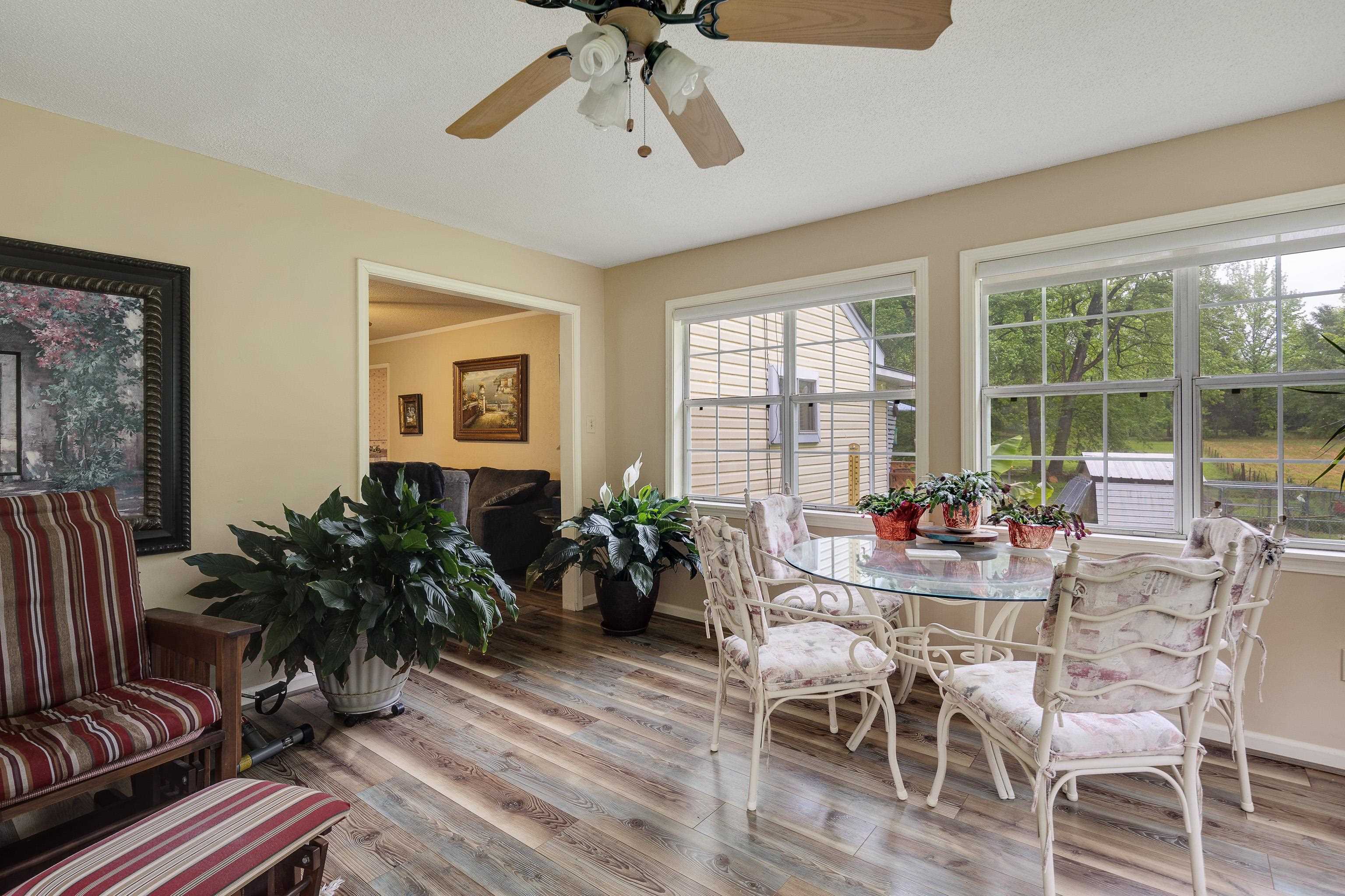 9252 Brunswick Road Millington, TN 38053 - Photo 15 of 40 a view of a dining room with furniture window and wooden floor
