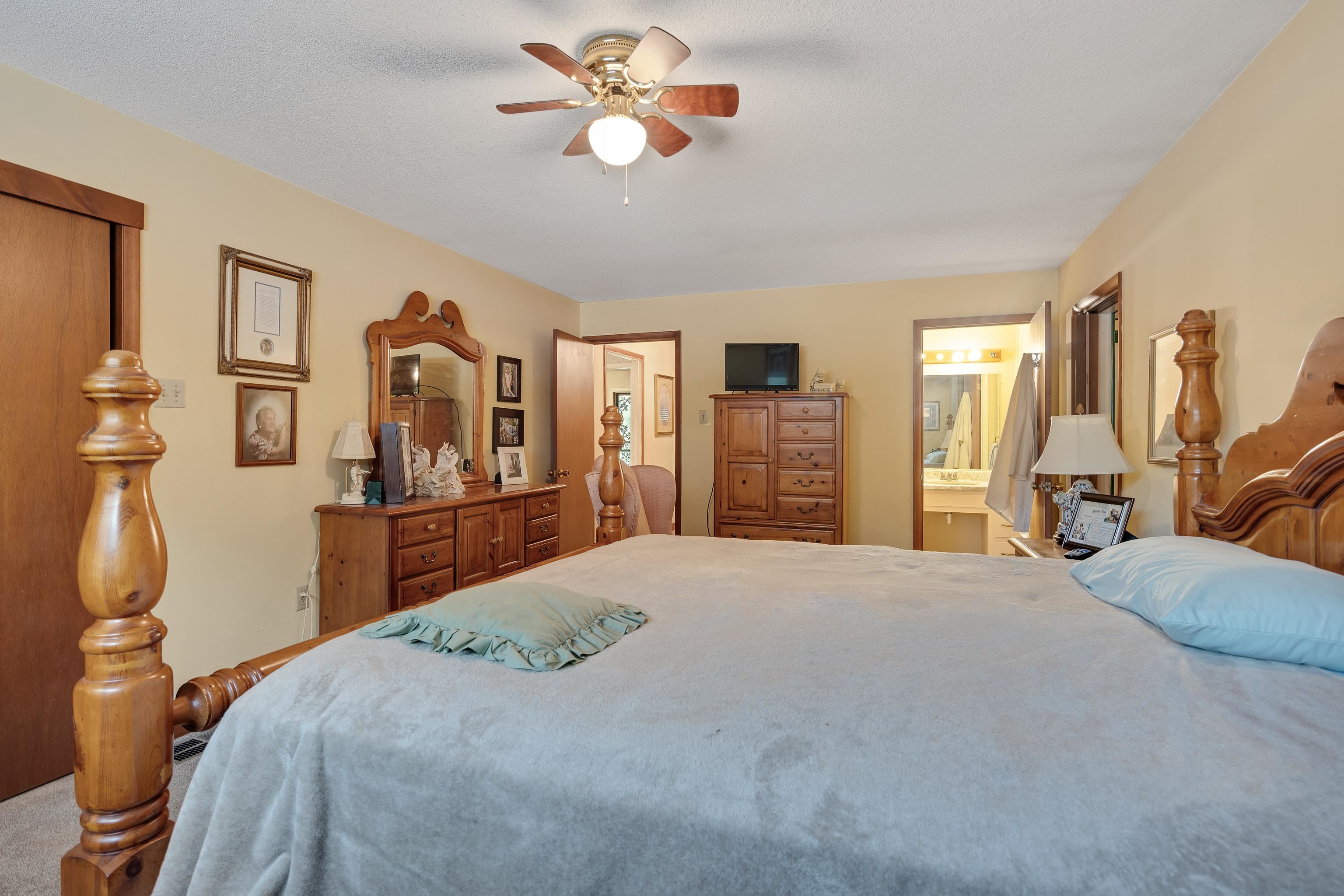 9252 Brunswick Road Millington, TN 38053 - Photo 21 of 40 a bedroom with a bed and a chandelier