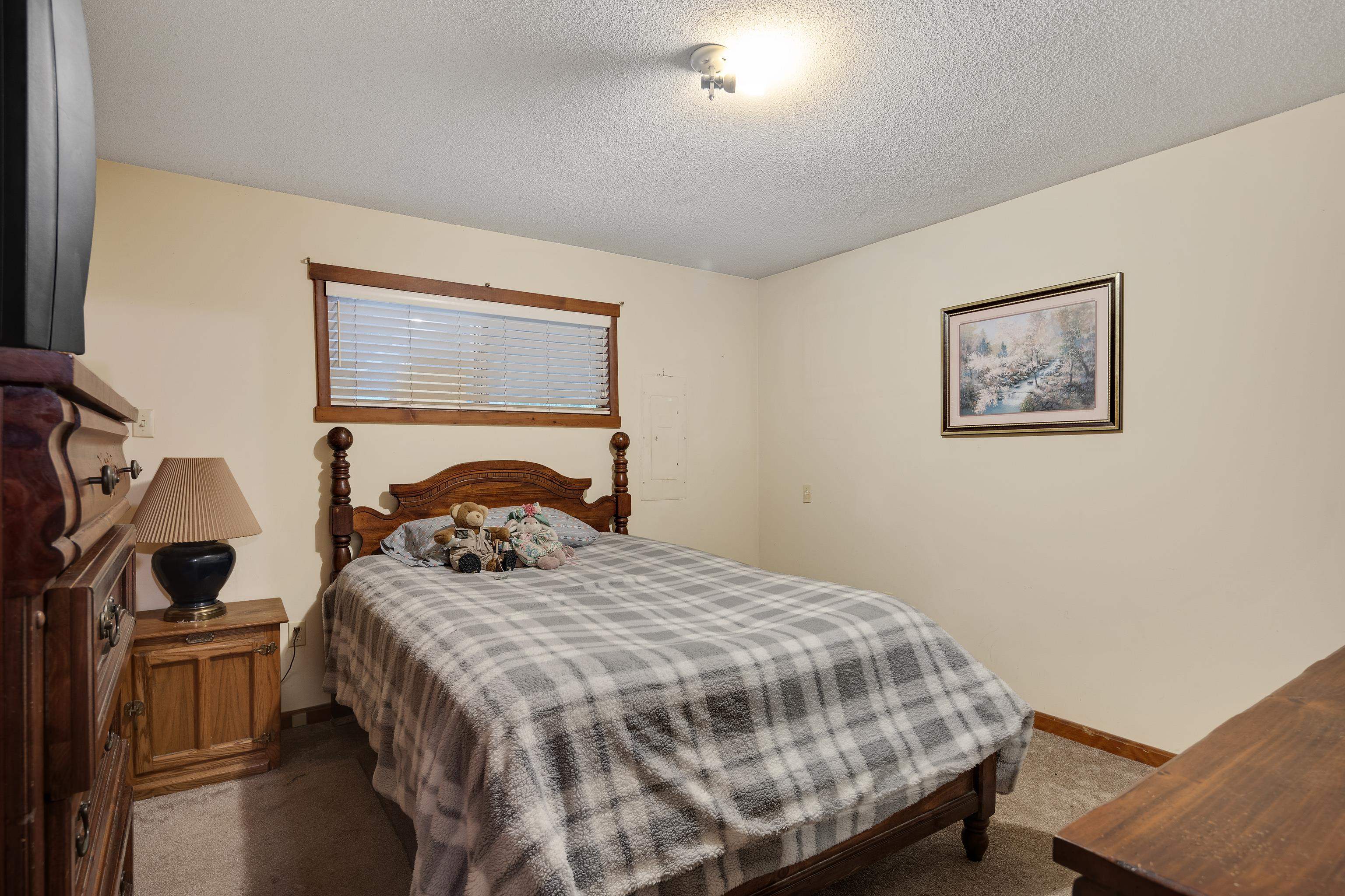 9252 Brunswick Road Millington, TN 38053 - Photo 25 of 40 a bedroom with a bed and a lamp on dresser