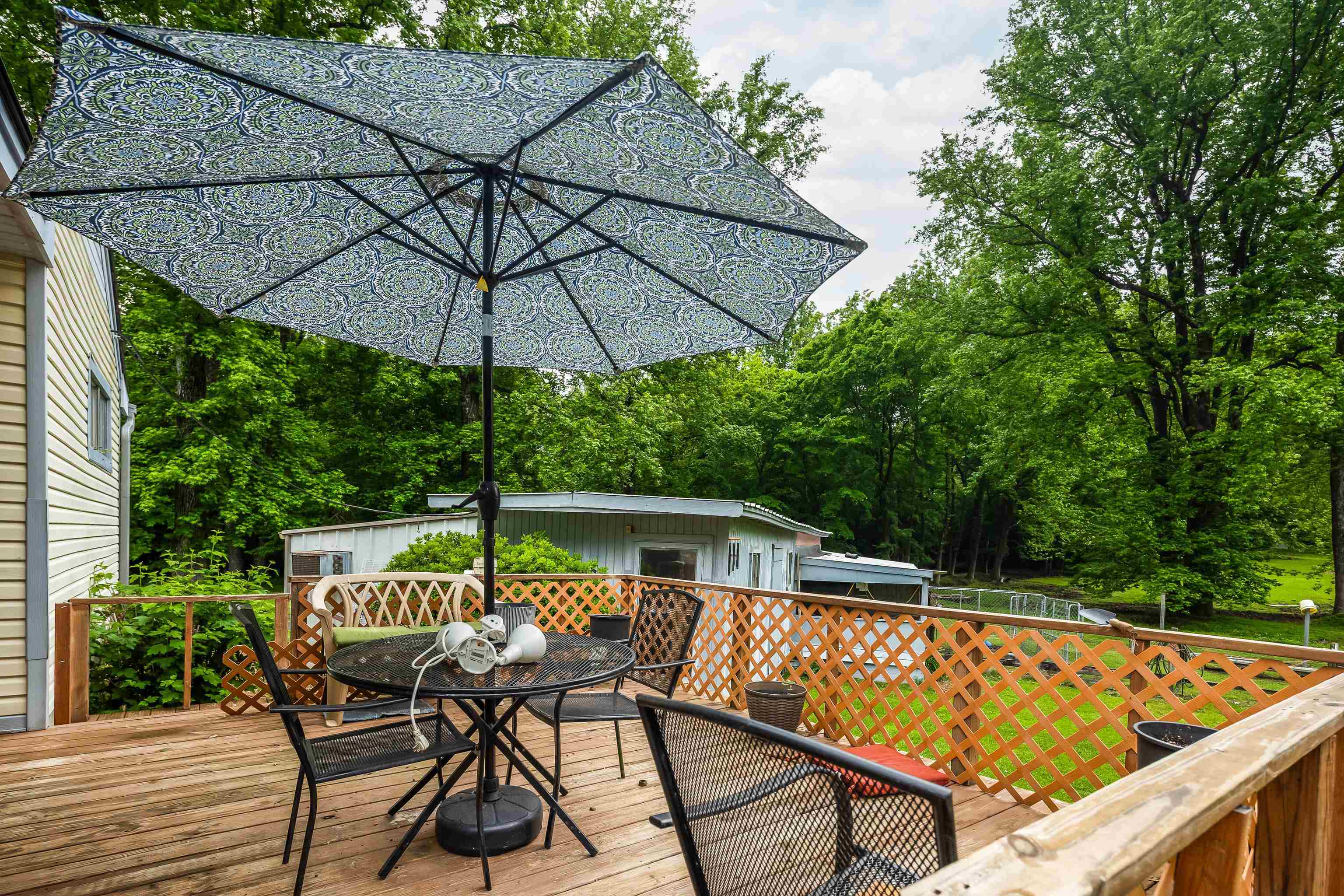 9252 Brunswick Road Millington, TN 38053 - Photo 26 of 40 a patio with wooden floor a yard a table and chairs