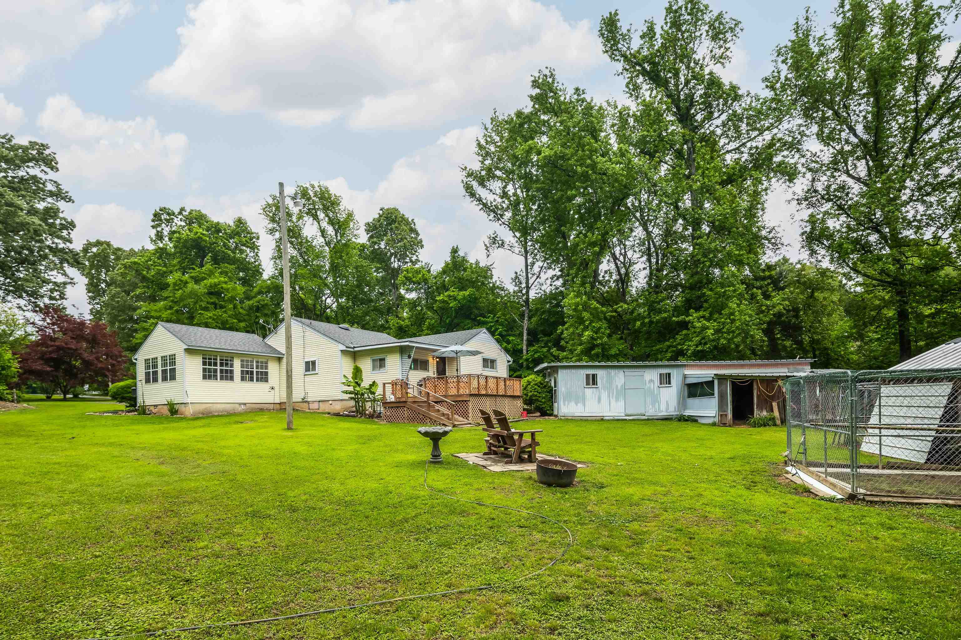 9252 Brunswick Road Millington, TN 38053 - Photo 35 of 40 a white house with a big yard and large trees with a big yard