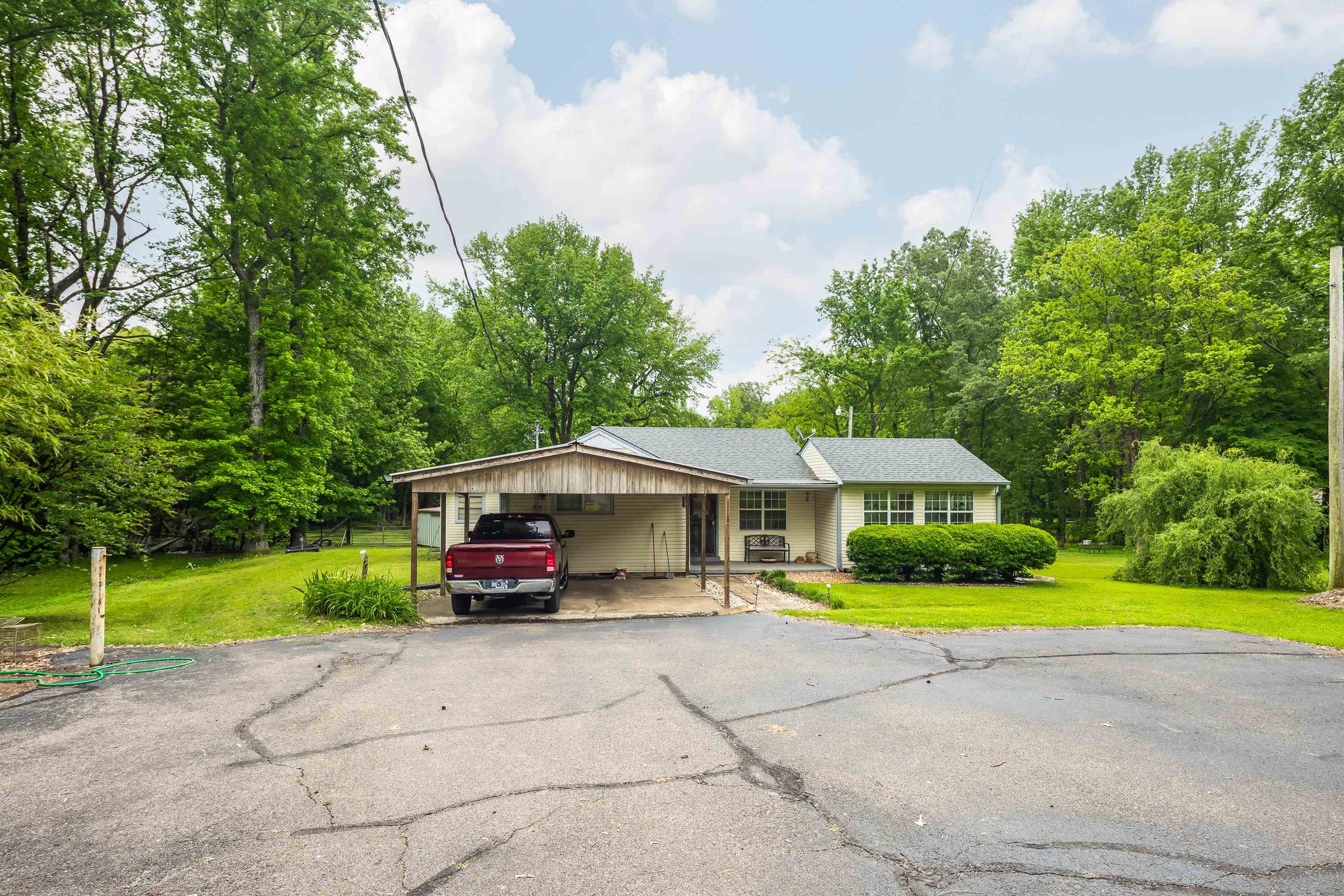 9252 Brunswick Road Millington, TN 38053 - Photo 9 of 40 a car parked in front of yellow house with swimming pool