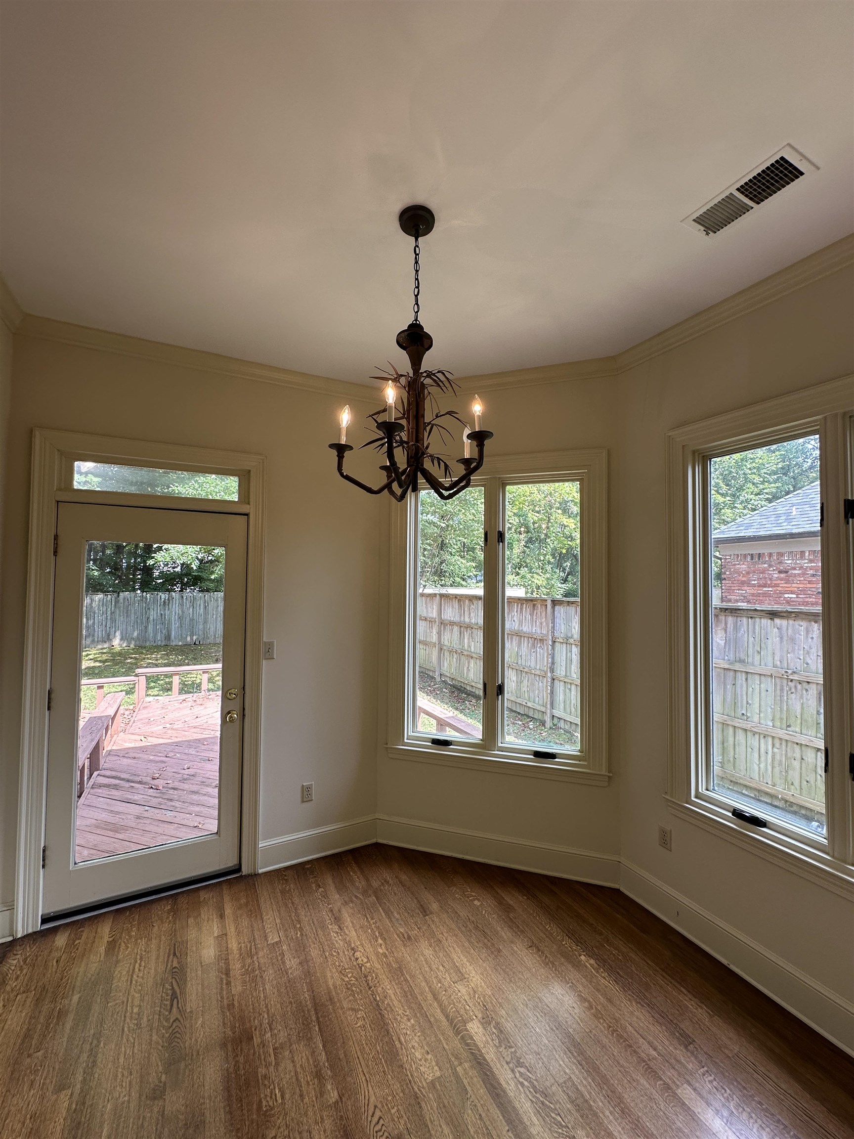 320 River Oaks Road North Memphis, TN 38120 - Photo 11 of 21 a view of an empty room with wooden floor and a window