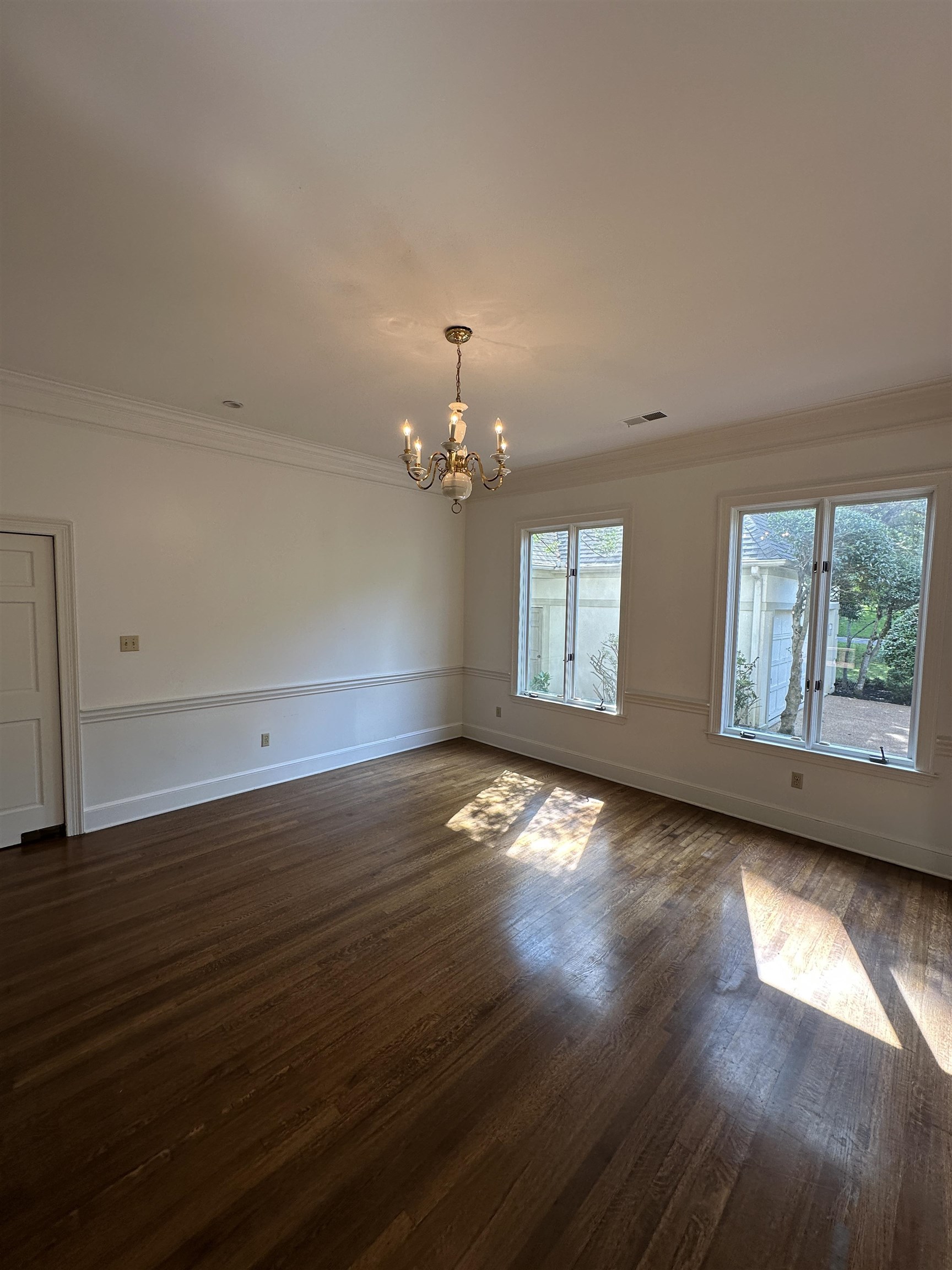 320 River Oaks Road North Memphis, TN 38120 - Photo 6 of 21 an empty room with wooden floor and windows