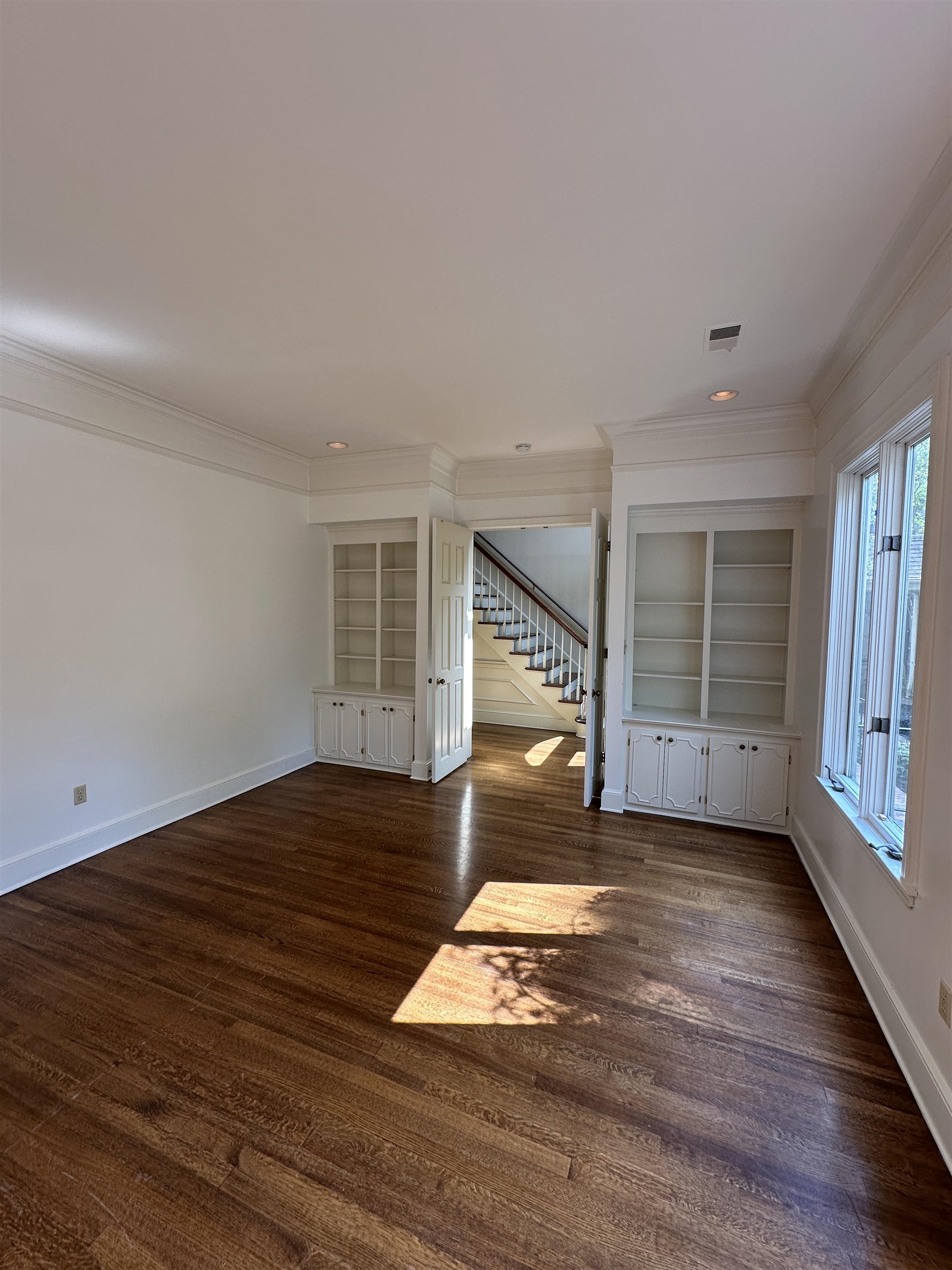 320 River Oaks Road North Memphis, TN 38120 - Photo 8 of 21 a view of empty room with wooden floor and fan
