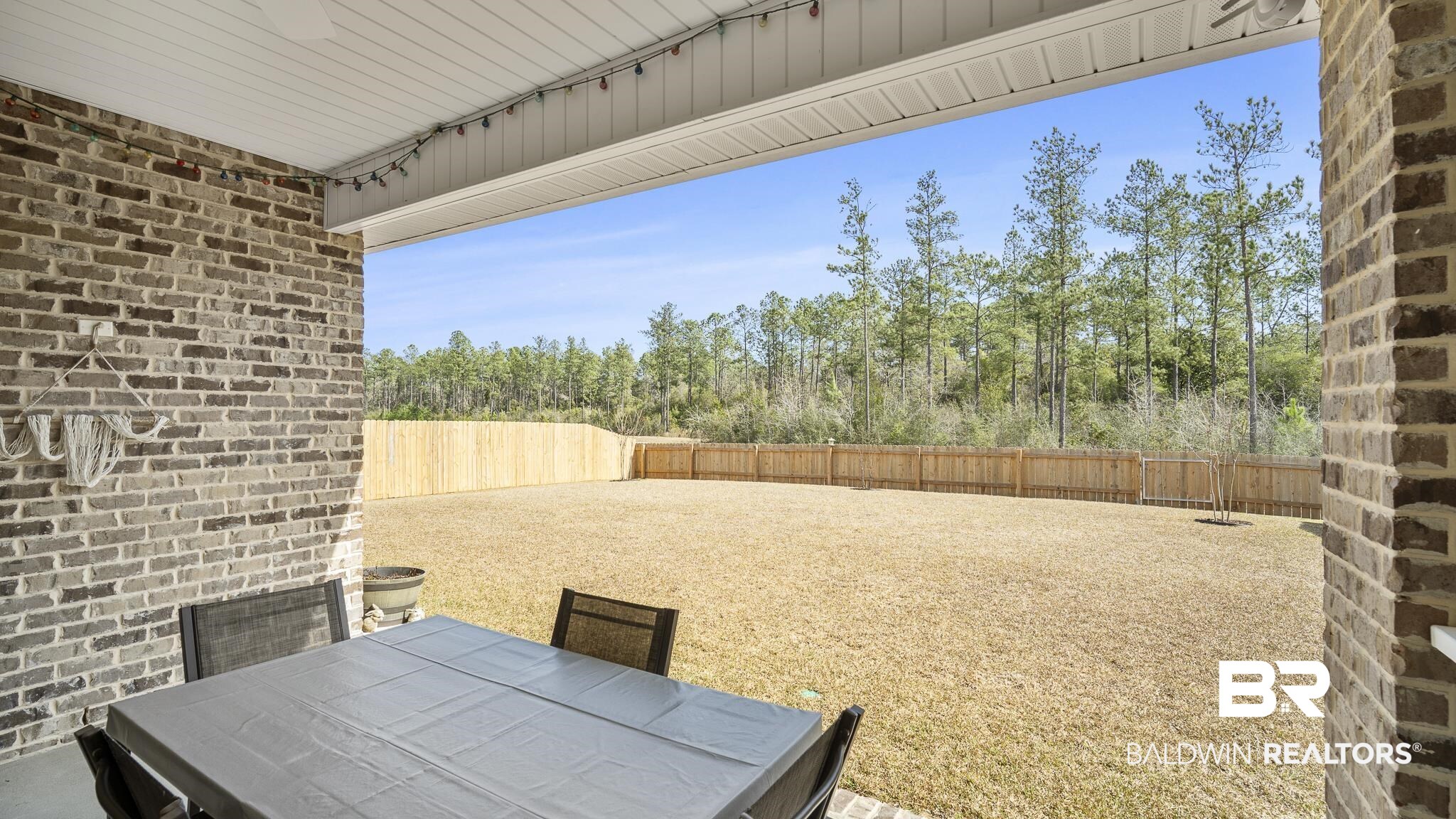 13887 Antler Hl Road Daphne, AL 36527 - Photo 25 of 50 Fenced backyard with a patio and outdoor dining space