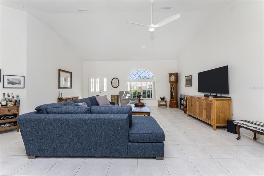 443 Rotonda Circle Rotonda West, FL 33947 - Photo 12 of 59 a living room with furniture and a flat screen tv