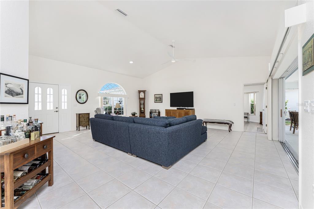 443 Rotonda Circle Rotonda West, FL 33947 - Photo 13 of 59 a living room with furniture and a flat screen tv