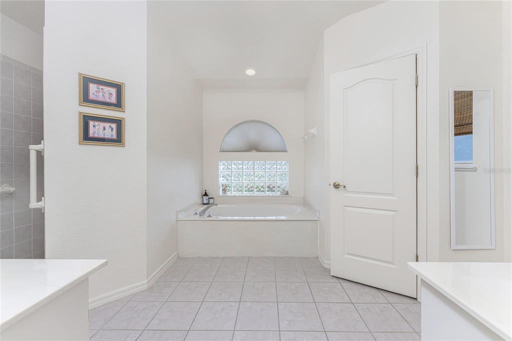 443 Rotonda Circle Rotonda West, FL 33947 - Photo 23 of 59 a bathroom with a bathtub and a shower