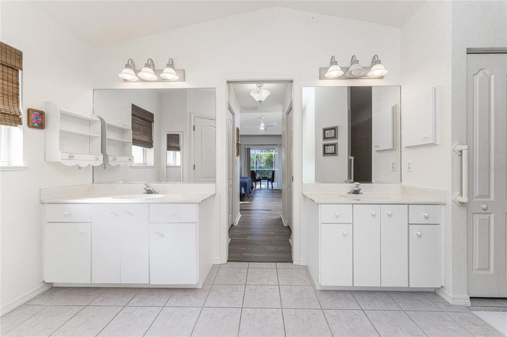 443 Rotonda Circle Rotonda West, FL 33947 - Photo 26 of 59 a bathroom with a sink vanity and mirror