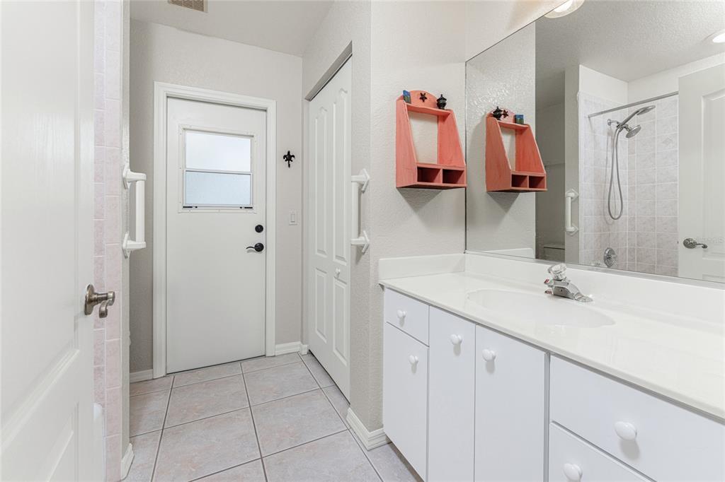 443 Rotonda Circle Rotonda West, FL 33947 - Photo 29 of 59 a bathroom with a sink and a mirror