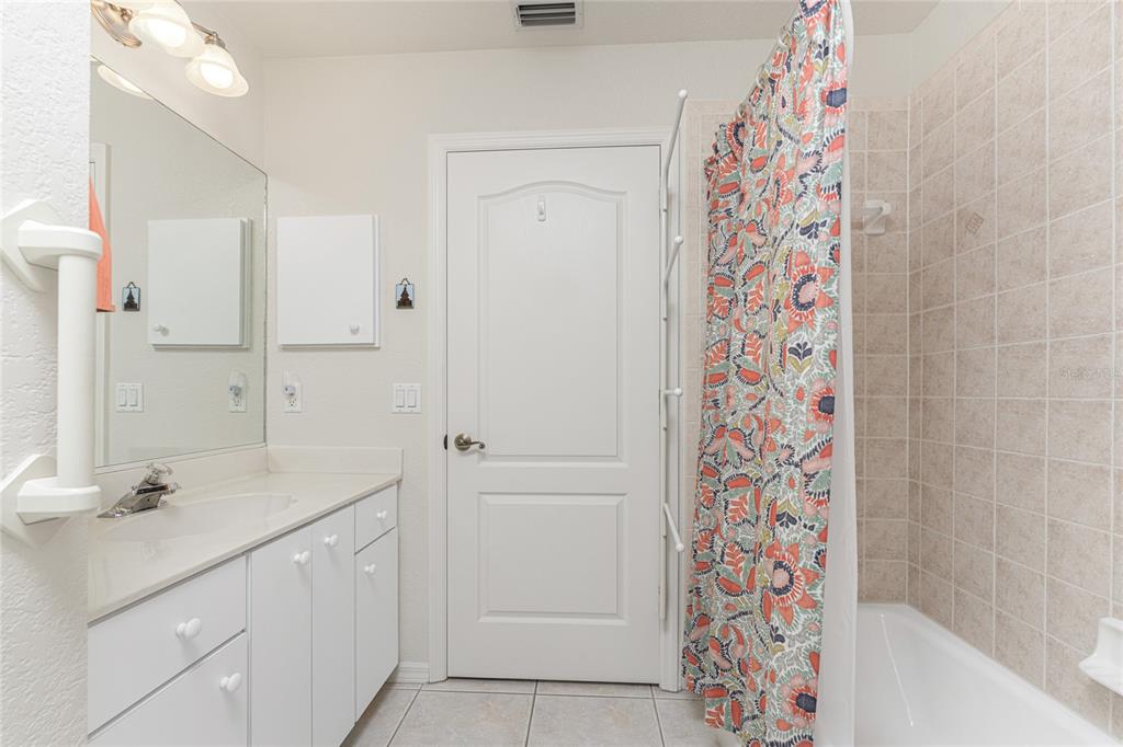 443 Rotonda Circle Rotonda West, FL 33947 - Photo 30 of 59 a bathroom with a shower curtain and a sink