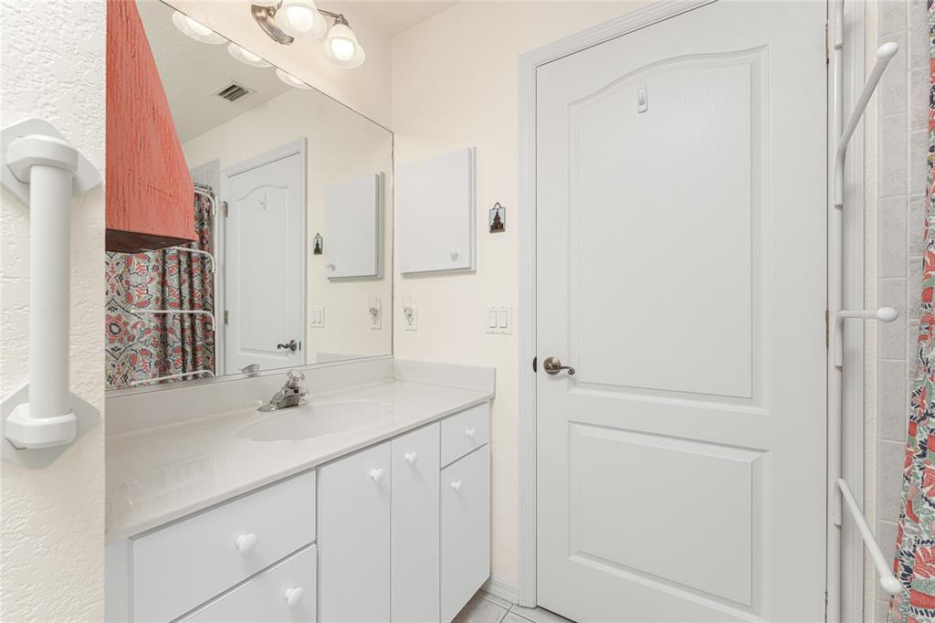 443 Rotonda Circle Rotonda West, FL 33947 - Photo 31 of 59 a bathroom with a sink vanity and a mirror