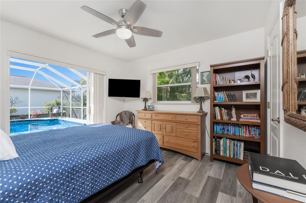 443 Rotonda Circle Rotonda West, FL 33947 - Photo 32 of 59 a spacious bedroom with a bed and a flat screen tv