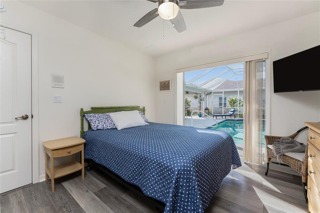 443 Rotonda Circle Rotonda West, FL 33947 - Photo 33 of 59 a bedroom with a bed and a flat screen tv