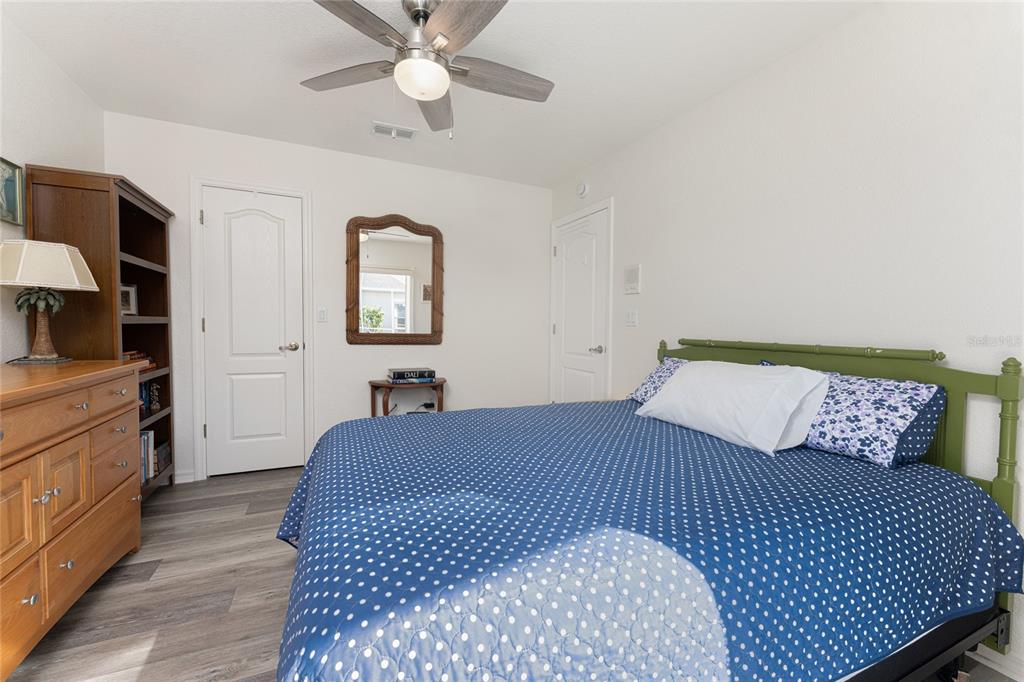 443 Rotonda Circle Rotonda West, FL 33947 - Photo 34 of 59 a bedroom with a bed and a chandelier