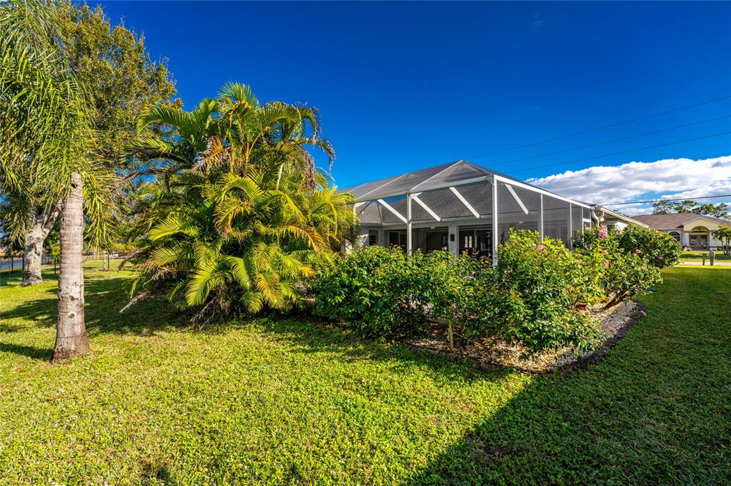 443 Rotonda Circle Rotonda West, FL 33947 - Photo 45 of 59 a view of a garden with a house in the background