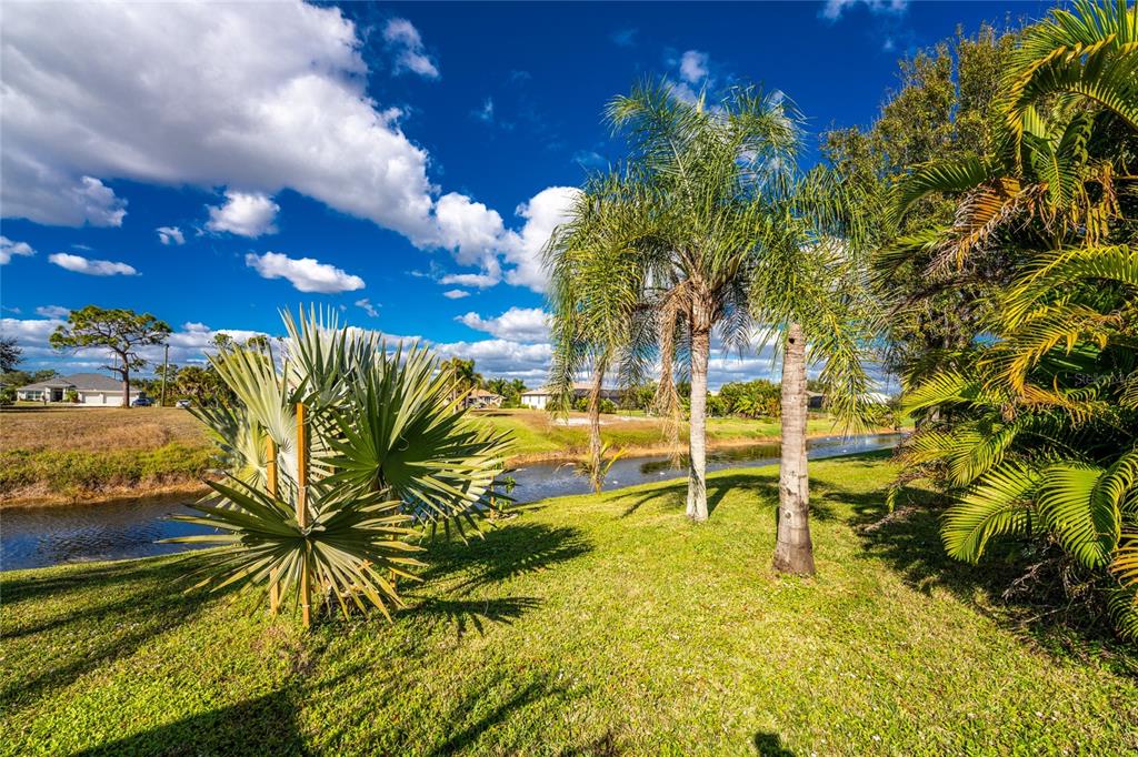 443 Rotonda Circle Rotonda West, FL 33947 - Photo 46 of 59 a view of a swimming pool with a lawn chairs and plants