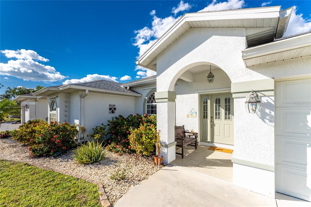 443 Rotonda Circle Rotonda West, FL 33947 - Photo 7 of 59 a front view of a house with garden