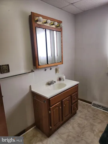 a bathroom with a sink a mirror and a window