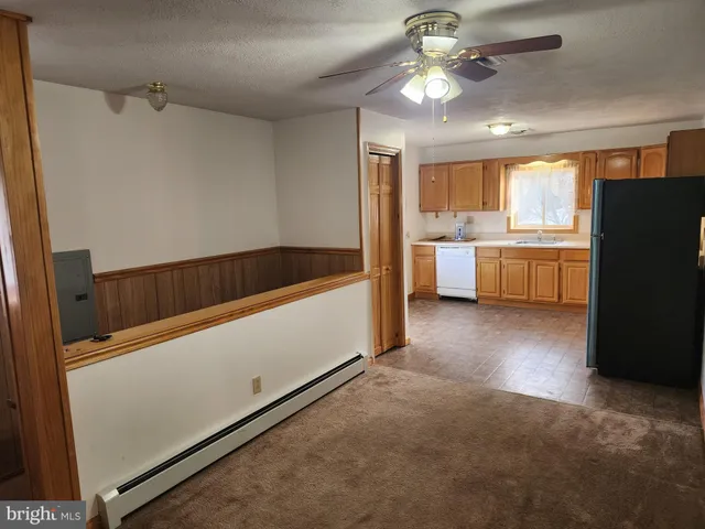 a kitchen with a refrigerator and a sink