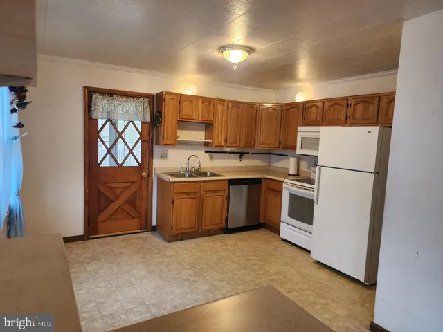 a kitchen with a refrigerator sink and cabinets
