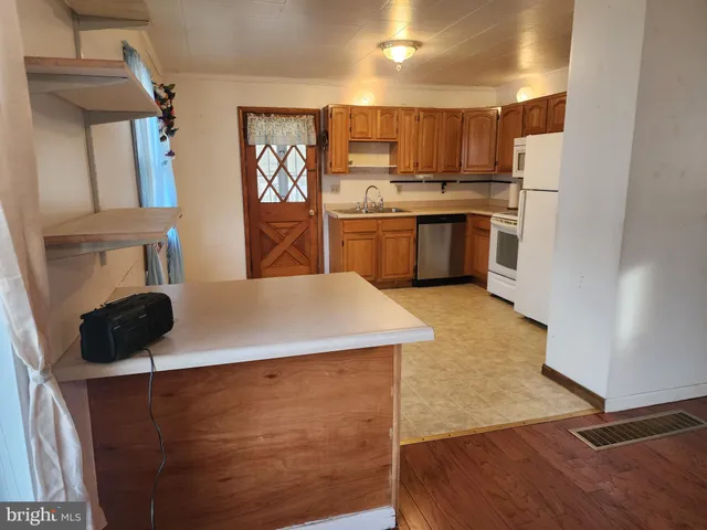 a kitchen with stainless steel appliances a stove a refrigerator and a sink