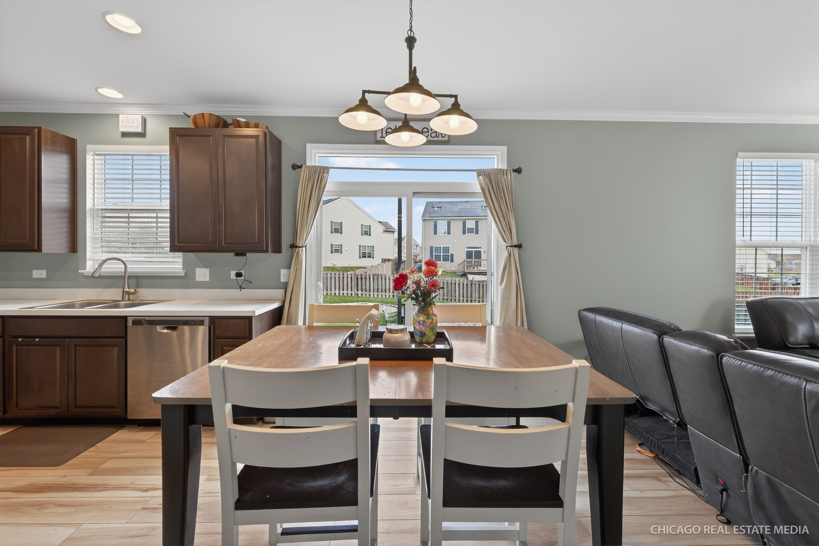 295 Monarch Lane Volo, IL 60020 - Photo 11 of 36 a kitchen with stainless steel appliances a dining table chairs and chandelier