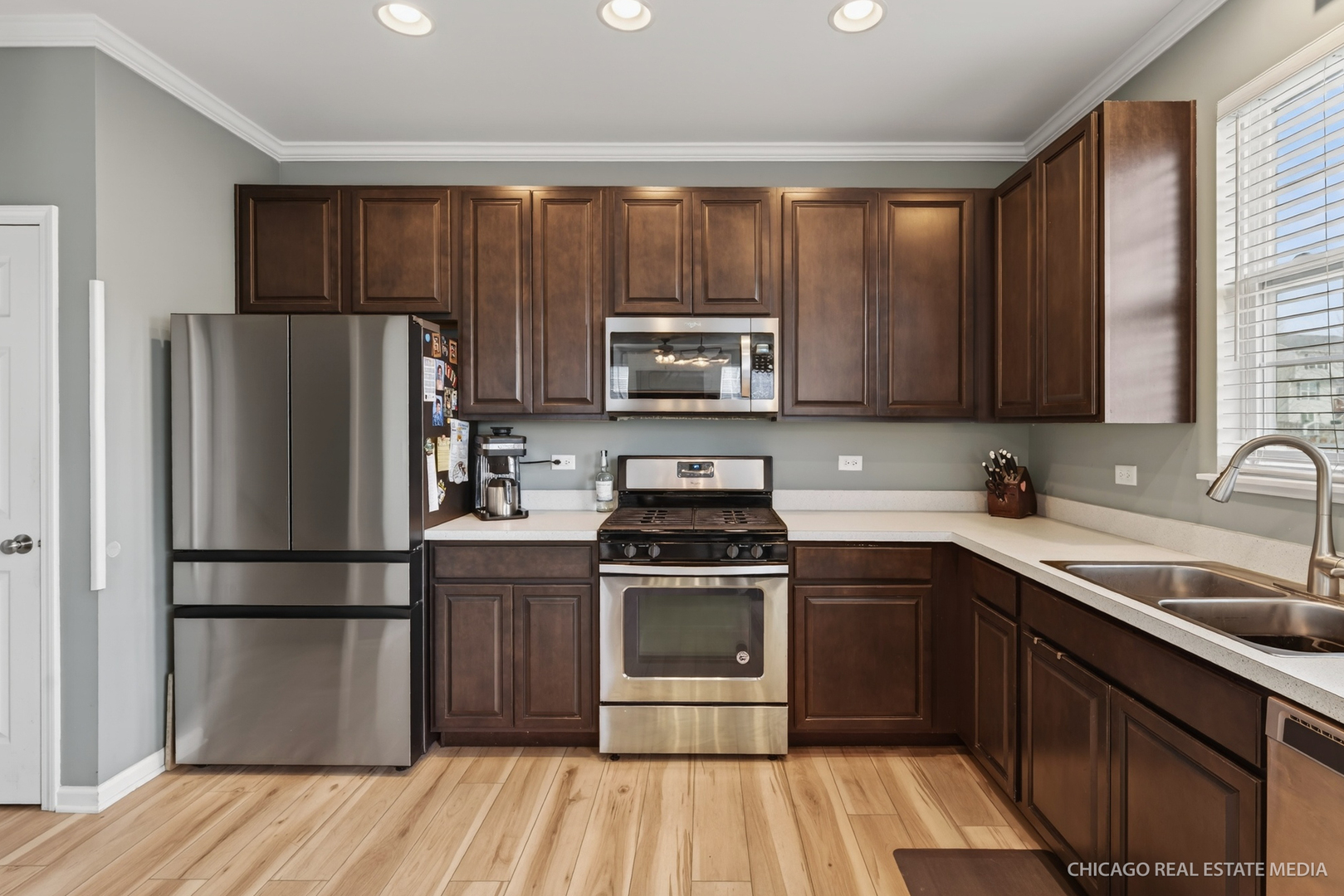 295 Monarch Lane Volo, IL 60020 - Photo 13 of 36 a kitchen with a sink stove and refrigerator
