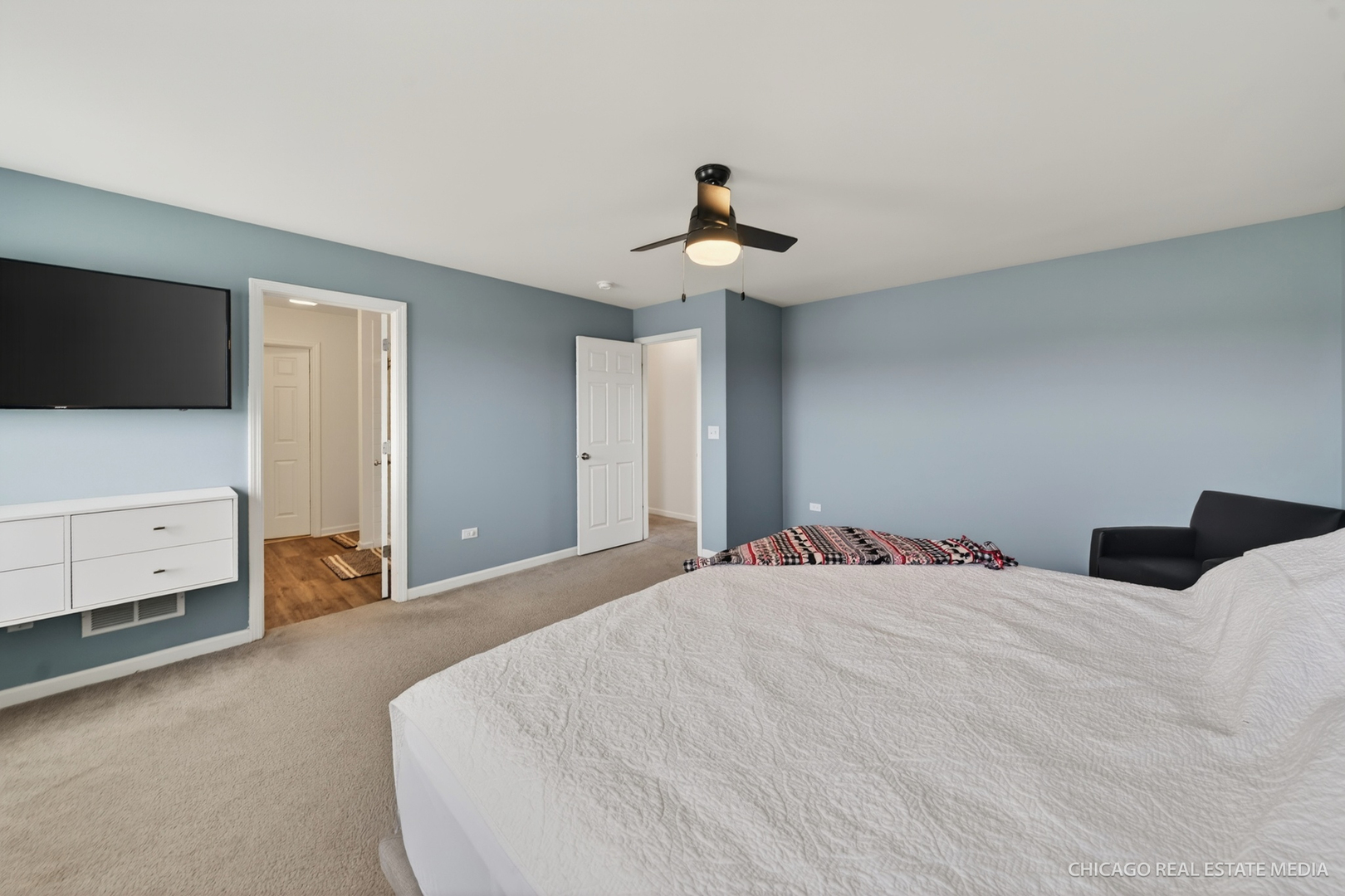 295 Monarch Lane Volo, IL 60020 - Photo 17 of 36 a bedroom with a bed and a flat tv screen on dresser