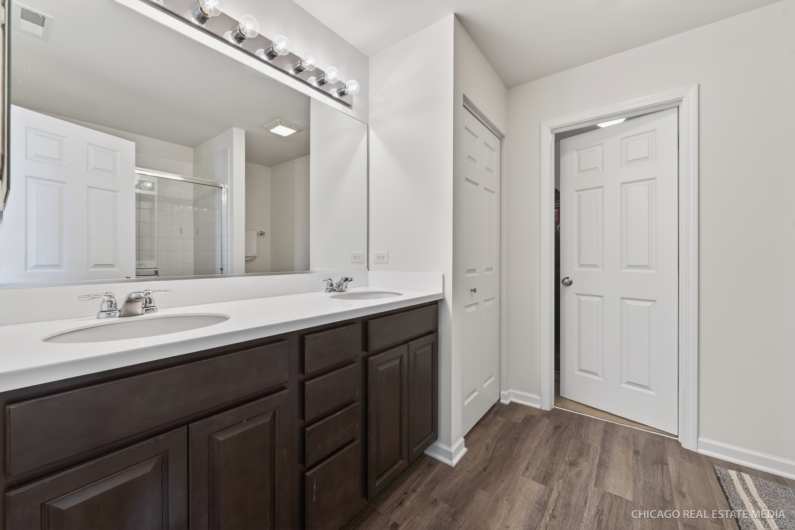 295 Monarch Lane Volo, IL 60020 - Photo 18 of 36 a bathroom with a double vanity sink and mirror