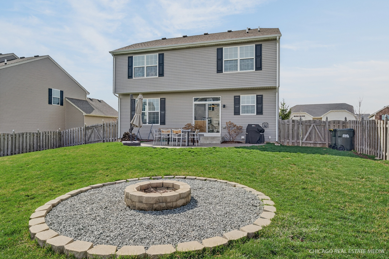295 Monarch Lane Volo, IL 60020 - Photo 27 of 36 a view of a house with a backyard porch and sitting area