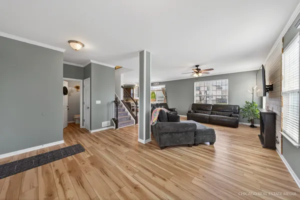 a living room with furniture and a wooden floor