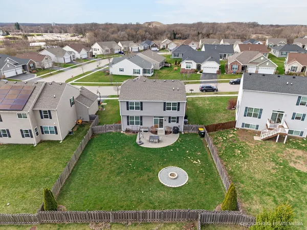 an aerial view of residential houses with outdoor space and parking