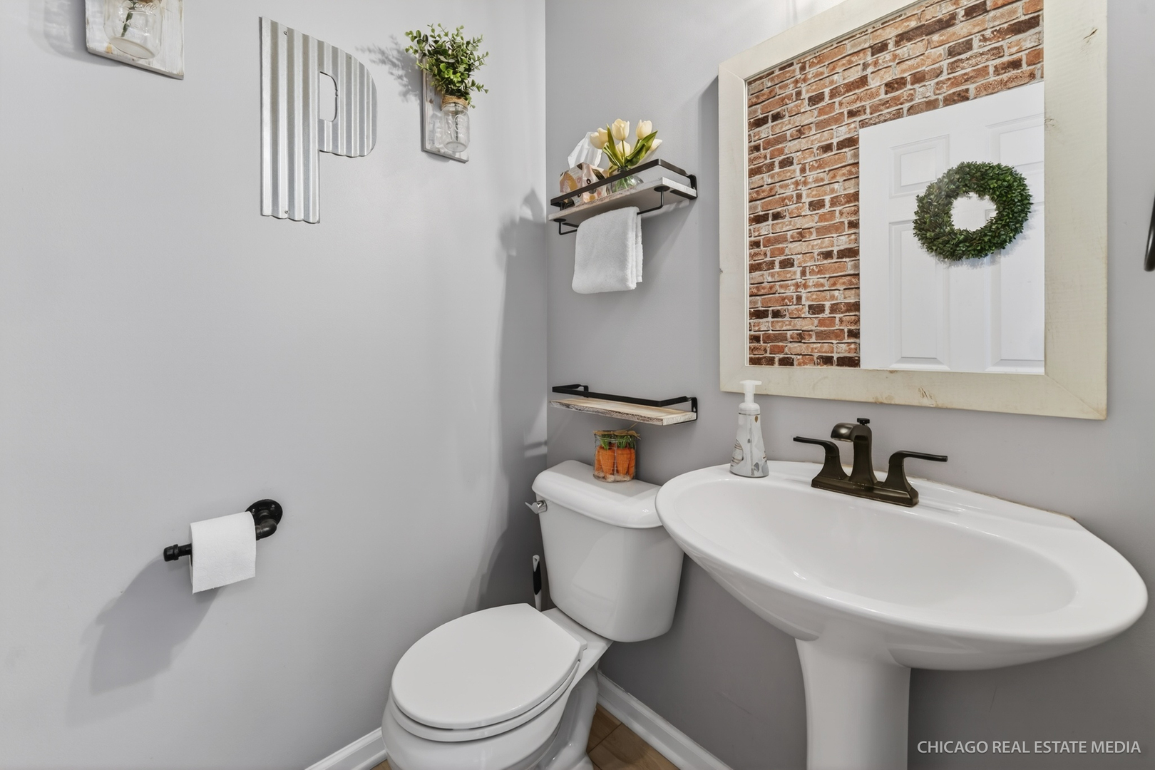 295 Monarch Lane Volo, IL 60020 - Photo 9 of 36 a bathroom with a toilet sink and mirror