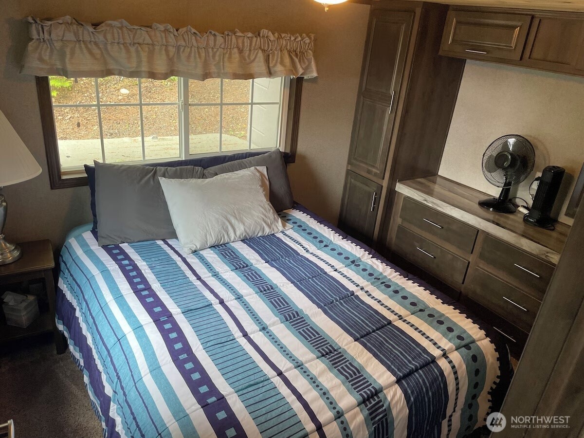 50 North Rustic Ridge Drive Lilliwaup, WA 98555 - Photo 14 of 40 a bedroom with a bed and a window