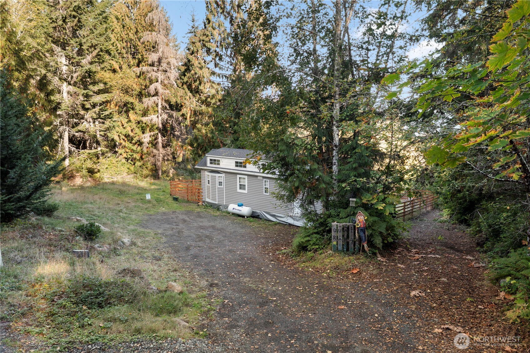 50 North Rustic Ridge Drive Lilliwaup, WA 98555 - Photo 4 of 40 a backyard of a house with a yard and garage