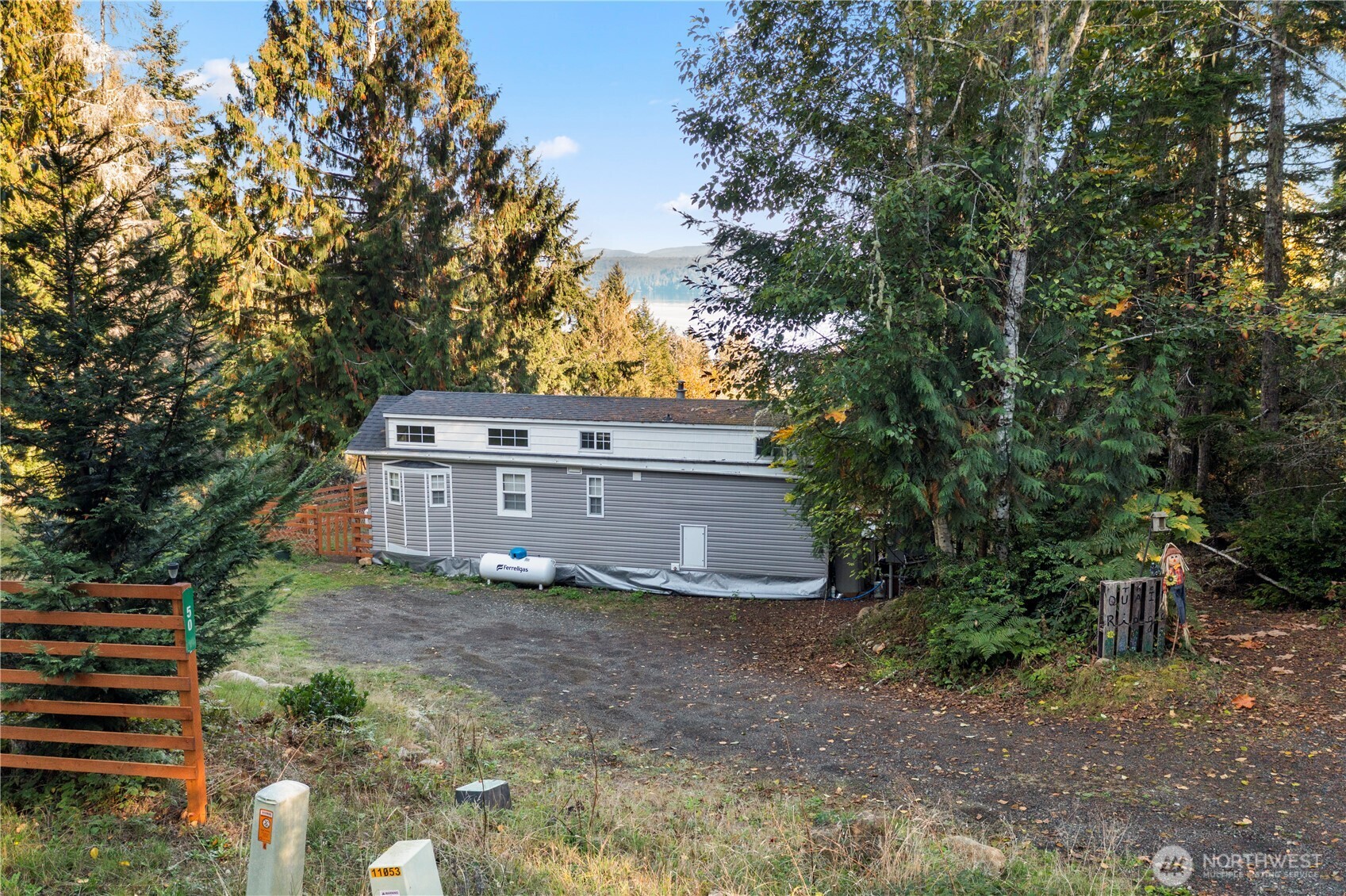 50 North Rustic Ridge Drive Lilliwaup, WA 98555 - Photo 5 of 40 a view of a house with a yard and large trees