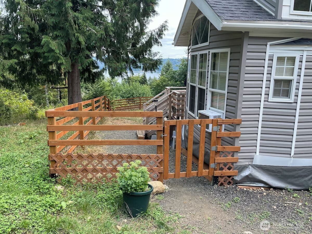 50 North Rustic Ridge Drive Lilliwaup, WA 98555 - Photo 7 of 40 a view of a house with a yard and potted plants