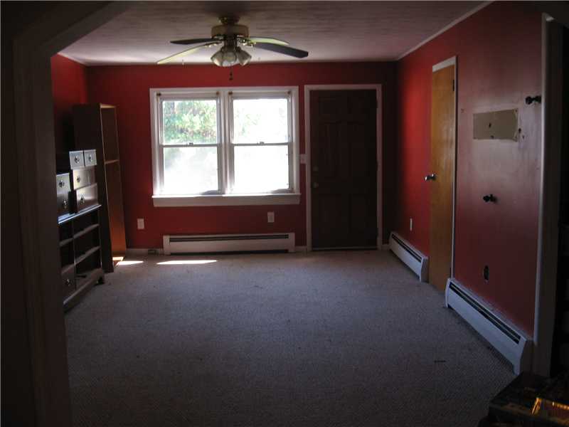 22 Babcock Road Westerly, RI 02891 - Photo 10 of 12 Living Room. The spacious living room in the larger apartment could use new wall paint and carpeting.