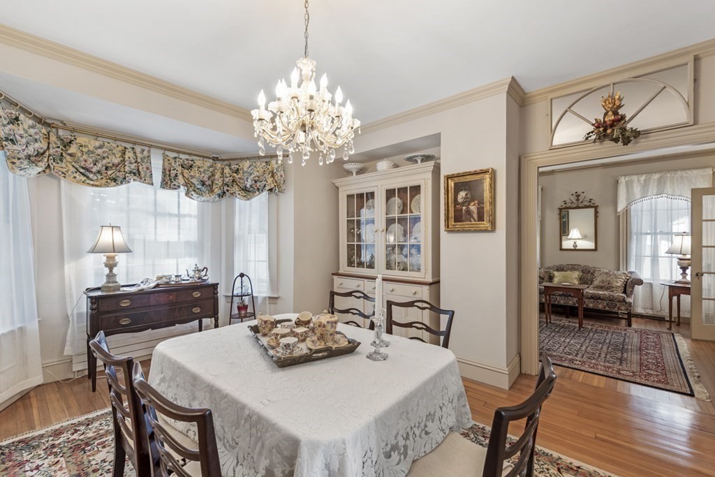 42 Willow Street Reading, MA 01867 - Photo 11 of 35 a view of a dining room with furniture a chandelier and wooden floor