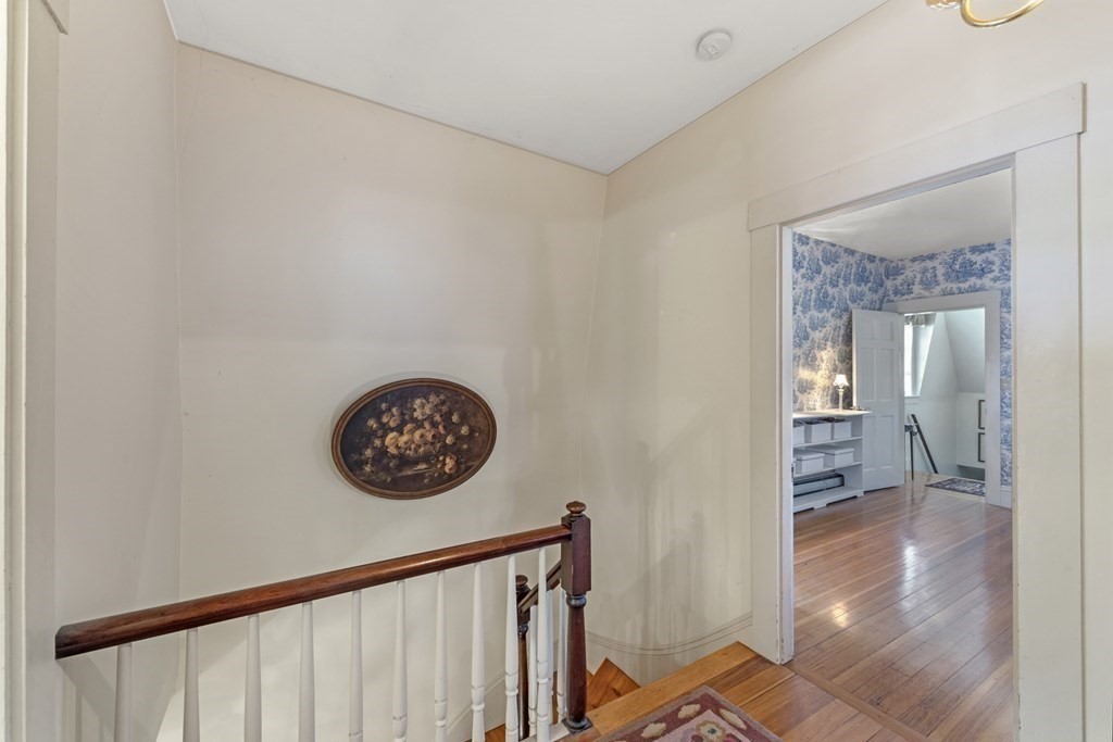 42 Willow Street Reading, MA 01867 - Photo 15 of 35 a view of a hallway with a wooden floor