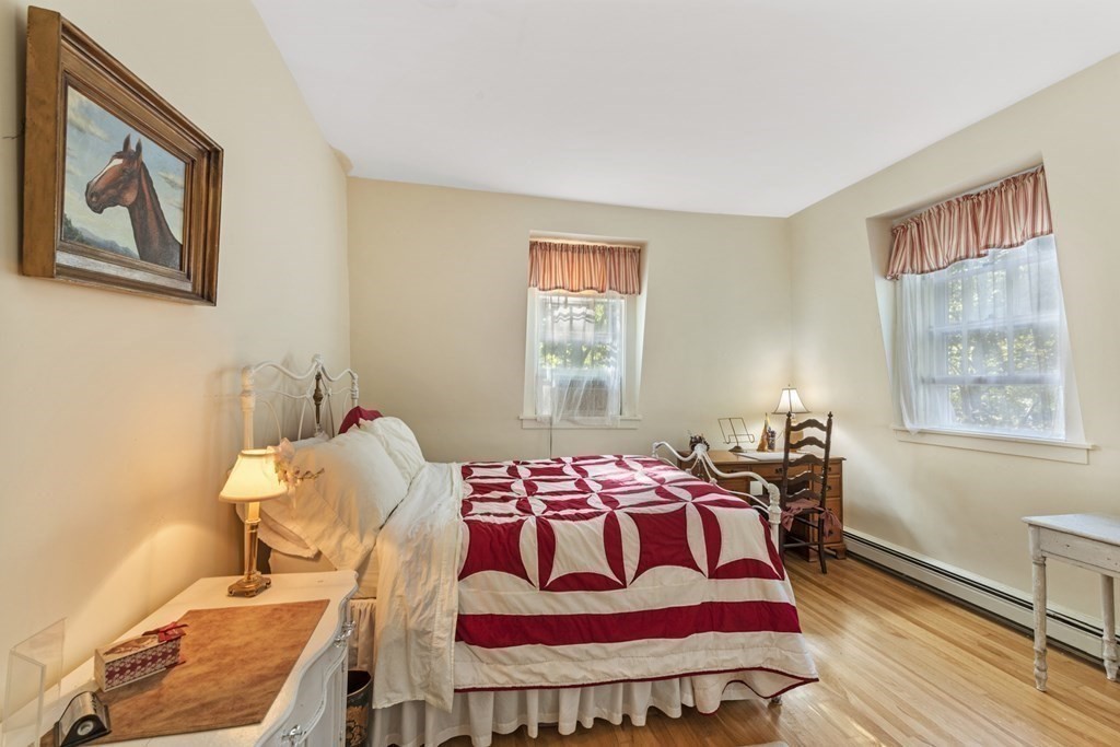 42 Willow Street Reading, MA 01867 - Photo 20 of 35 a bedroom with a bed and wooden floor