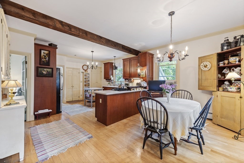 42 Willow Street Reading, MA 01867 - Photo 6 of 35 a dining room with furniture a chandelier and wooden floor