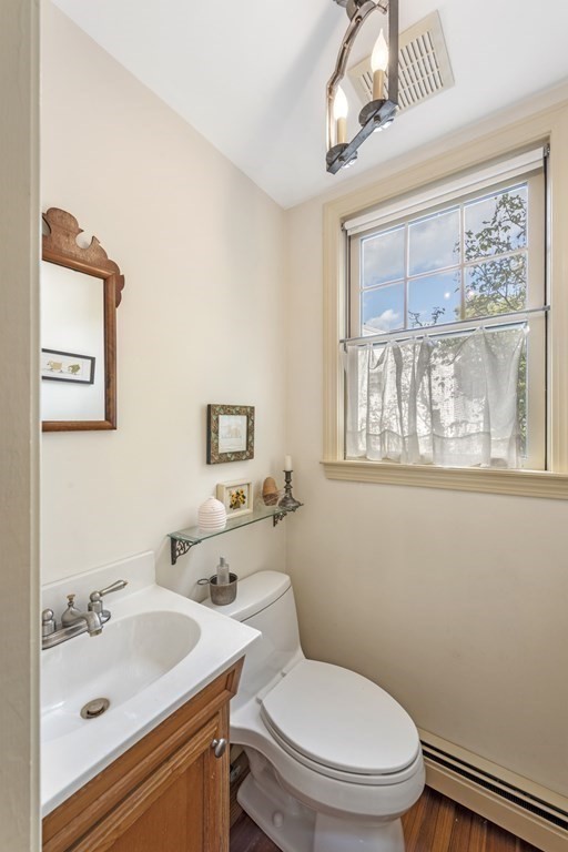 42 Willow Street Reading, MA 01867 - Photo 9 of 35 a bathroom with a toilet a sink a mirror and a window